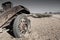 Wrecked antique car with wire wheel  in the desert