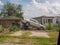 Wrecked car on top of truck in front of damaged houses after Hurricane Katrina