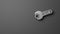 Wrench tightening  nut on gray background, thirty frame