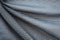 Wrinkled gray mesh sport fabric with large diagonal folds