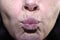 wrinkled lips of a middle-aged woman, 40-45 years