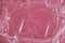 Wrinkled transparent plastic texture on an pink background. Transparent cellophane texture on an pink backing. Top view. Copy,