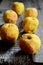 Wrinkled yellow apples on a wooden