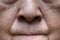 Wrinkles and loosening skin around the lips of Asian, Chinese elder woman