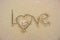 Write love wrote on the sand.