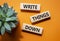 Write things down symbol. Concept words Write things down on wooden blocks. Beautiful orange background with succulent plant.