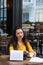 Writer female working in an outdoor cafe using a retro typewrite