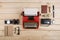 Writer or journalist workplace vintage red typewriter, photo camera, cassette recorder on the wooden desk