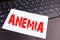 Writing Anemia text made in the office close-up on laptop computer keyboard. Business concept for Medical Diagnosis Iron deficienc