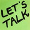 Writing on colorful sticky note Let`s talk. Text with Let`s talk on paper