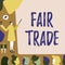 Writing displaying text Fair Trade. Concept meaning Small increase by a manufacturer what they paid to a producer Lady