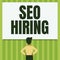 Writing displaying text Seo Hiring. Internet Concept employing a specialist will develop content to include keywords Man