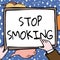 Writing displaying text Stop Smoking. Business idea Discontinuing or stopping the use of tobacco addiction Hands Holding