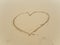 Writing heart on beach