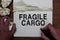 Writing note showing Fragile Cargo. Business photo showcasing Breakable Handle with Care Bubble Wrap Glass Hazardous Goods Man hol