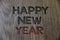 Writing note showing Happy New Year. Business photo showcasing congratulations Merry Xmas everyone beginning of January Wooden wo