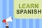 Writing note showing Learn Spanish. Business photo showcasing Translation Language in Spain Vocabulary Dialect Speech Man holding