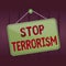 Writing note showing Stop Terrorism. Business photo showcasing Resolving the outstanding issues related to violence Memo reminder