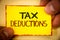 Writing note showing Tax Deductions. Business photo showcasing Reduction on taxes Investment Savings Money Returns Text Words yel