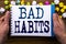 Writing text showing Bad Habits. Business concept for Improvement Break Habitual Hebit written on notepad notebook book on the woo