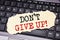 Writing text showing Don t Give Up. Business concept for Motivation Determination, written on sticky note paper on the black keybo