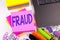 Writing text showing Fraud made in the office with surroundings such as laptop, marker, pen. Business concept for Criminal hacker