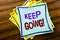 Writing text showing Keep Going. Business concept for Go Moving Forward Letting written on sticky note paper on the wooden backgro