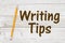 Writing Tips message with a pencil whitewash wood