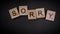 Writing the word Sorry with wooden letters