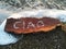 Written CIAO is a wood bark on the beach