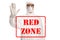 Written text red zone and a man in a white hazmat suit and mask gesturing stop