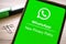 Written whatsapp new privacy policy on the green screen of a smartphone. Telephone with new agree update security rules on