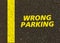 Wrong parking written on the road.