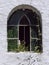 Wrought iron arch window in old church wall