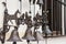 Wrought iron bells with figures of bull, horse, birds and flowers on the white wall of the building.