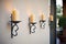 wrought iron candle sconces on textured stucco walls