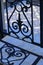 Wrought iron gate. Blue / white ceramic tiles