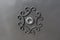 Wrought iron gate ornament on grey metal plate