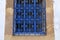 Wrought iron window grille painted blue