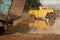 WS view of waterlogged muddy roadside constructon vehicles with