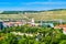 Wurzburg cityscape. Ferris wheel and manicured vineyards on the slopes in the background. Germany