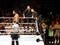 WWE Wrestler Jinder Mahal stands in ring with The Singh Brothers during pre-match ritual in WWE ring