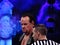 WWE Wrestler the Undertaker stares across ring with ref standing