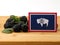 Wyoming flag on a wooden panel with blackberries isolated on a w