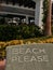 "beach please" towel at a beach resort