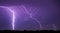 It's a breathtaking portrayal of a lightning thunderstorm over the night sky.