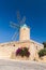 Xaghra Ggantija street view with old windmill under blue sky