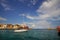 Xania, Crete, October 01 2018 Panoramic view of the Venetian harbor with its ancient lighthouse and a sailing vessel