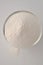 Xanthan gum - a white powder for gluten free baking and cooking, closeup on white background