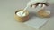 Xanthan gum in wooden bowl. A gloved hand dials dose of powder with measuring spoon. Food additive E415. Xanthan Gum Powder